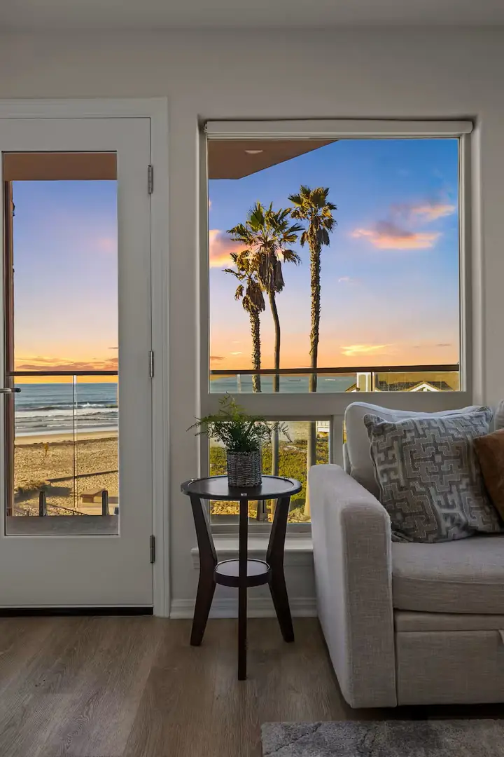 Furnished living room with palm trees and sunset view